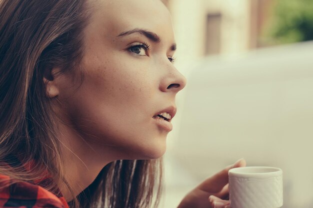 Pretty girl drinks coffee