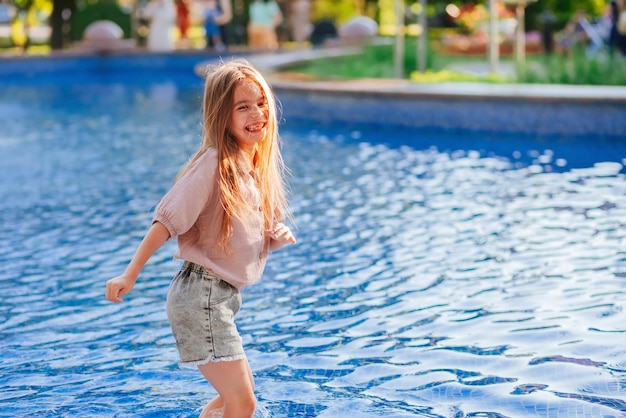 pretty girl having fun in the pool