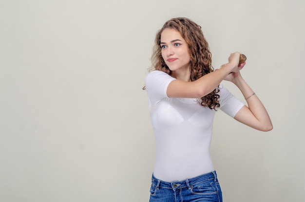 Pretty girl holds a hammer in hands swings to strike