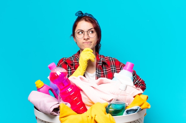 Pretty girl housekeeper washing clothes