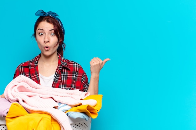 Pretty girl housekeeper washing clothes