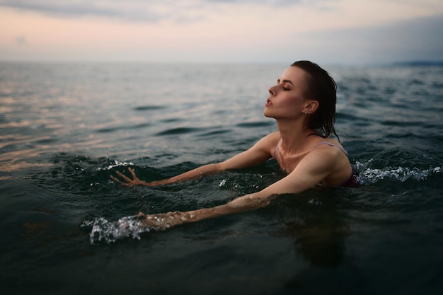 Pretty girl is swimming in the sea