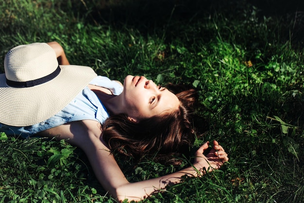 Pretty girl laying on green grass