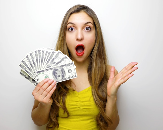 Pretty girl looking at camera with money banknotes