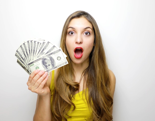 Pretty girl looking at camera with money banknotes