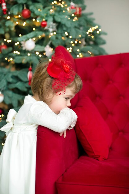 Pretty girl near the Christmas tree