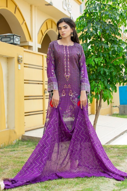 Pretty Girl Posing in House Lawn Confidently Wearing Purple Desi Dress for Fashion Shoot