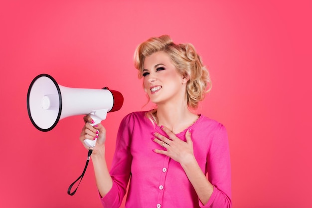 Pretty girl shouting into megaphone isolated copy space Girl portrait with megaphone Girl face with open mouth speaks in a loudspeaker Megaphone speech woman screaming