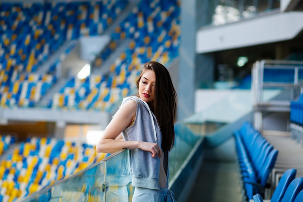 Pretty girl sitting at school stadium