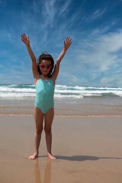 Pretty girl smiling while playing on the seashore in Fuerteventura