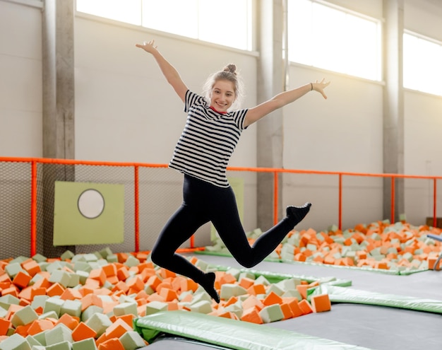 Pretty girl in trampoline park having fun