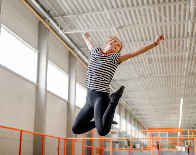 Pretty girl in trampoline park having fun