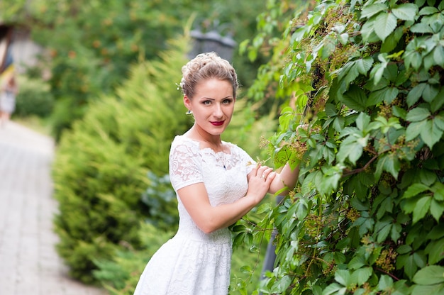 Pretty girl in a white dress outdoors.