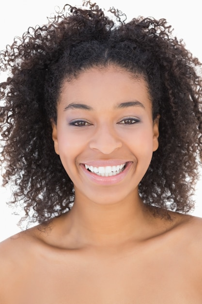 Pretty girl with afro hairstyle smiling at camera