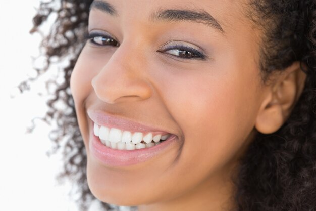 Pretty girl with afro hairstyle smiling at camera