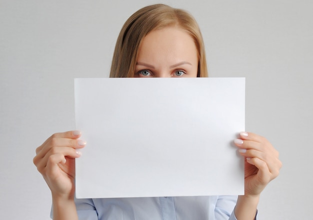 Pretty girl with empty paper sheet