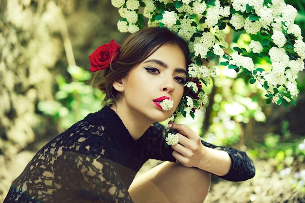 Pretty girl with fashionable spanish makeup rose flower in hair