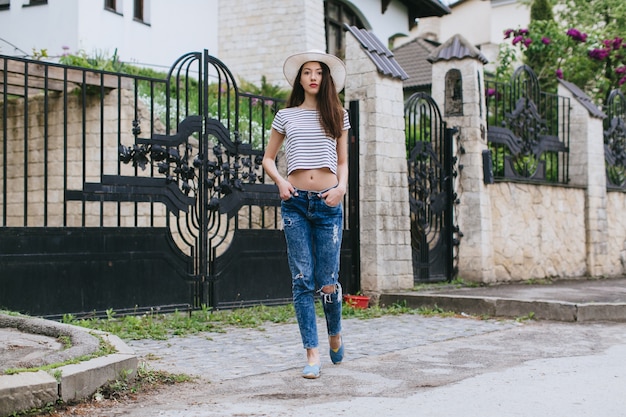 pretty girl with hat walking