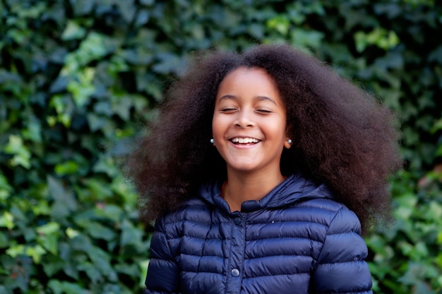 Pretty girl with long afro hair in the garden  