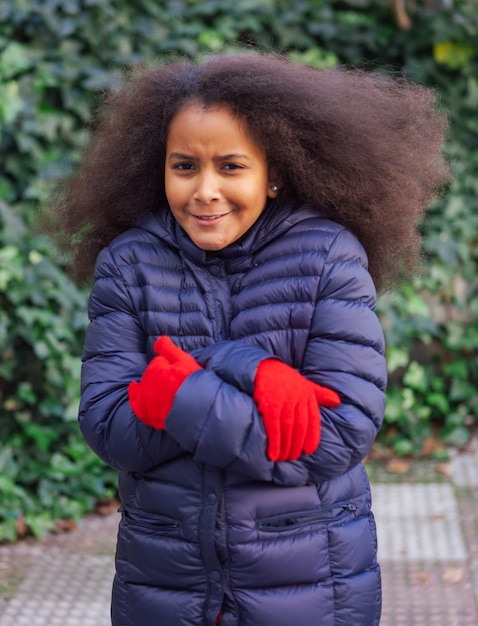 Pretty girl with long afro hair with a blue coat