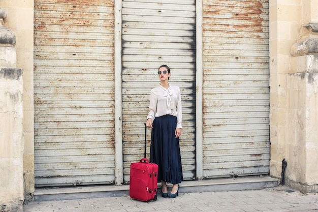 pretty girl with a red luggage