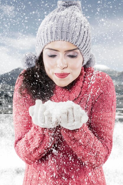 Pretty girl with snow at winter day