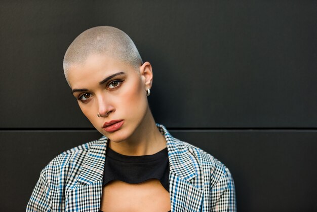 Pretty girl with stylish clothes posing - Beautiful woman with shaved head portrait