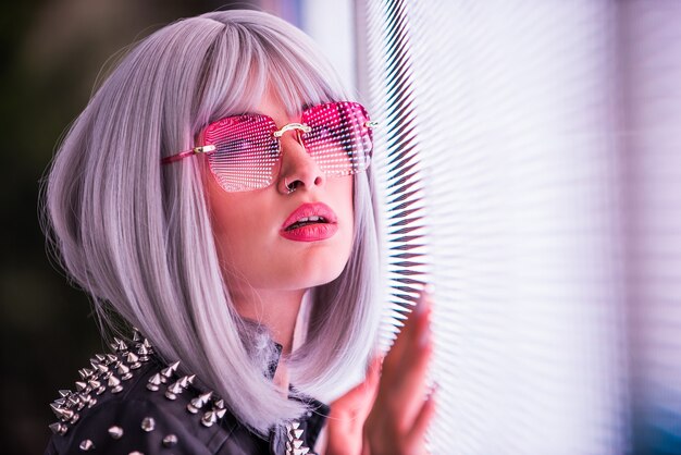 Pretty girl with stylish clothes posing near led lights - Beautiful woman portrait