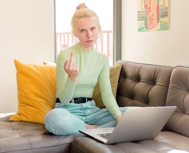 Pretty girl woman feeling angry, annoyed, rebellious and aggressive, flipping the middle finger, fighting back