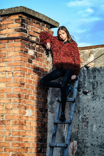 Pretty girl on wooden ladder