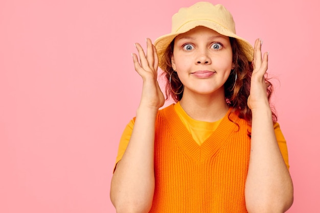 Pretty girl in yellow hat fashion posing emotions cropped view unaltered