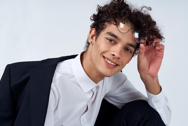 Pretty guy in glasses and in a classic suit on a light background portrait closeup fashion style