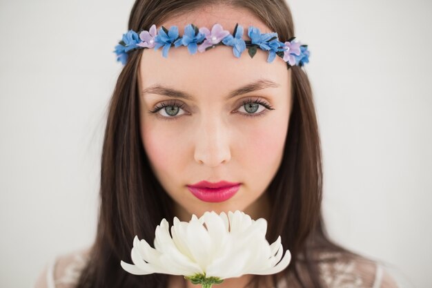 Pretty hippie smelling a flower