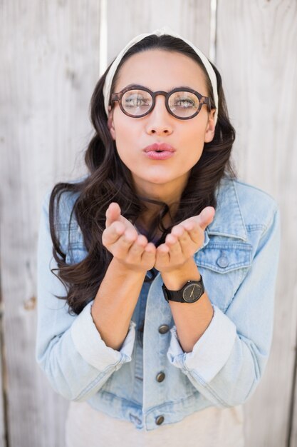 Pretty hipster blowing a kiss