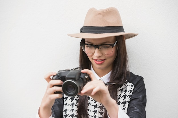 Pretty hipster looking at her camera