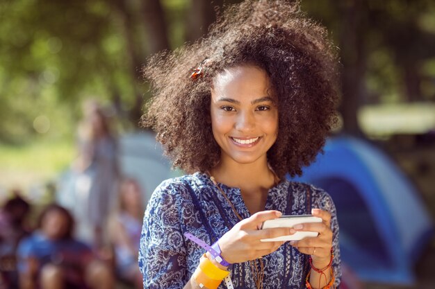 Pretty hipster sending text message