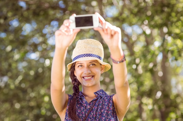 Pretty hipster taking a selfie