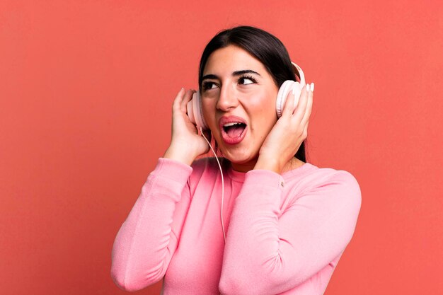 Pretty hismanic woman listening music and dancing