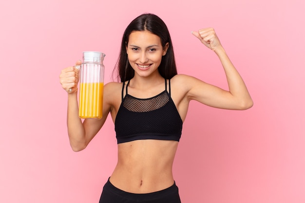 Pretty hispanic fitness woman with an orange juice