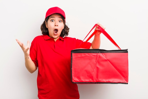 Pretty hispanic girl feeling extremely shocked and surprised fast food delivery concept