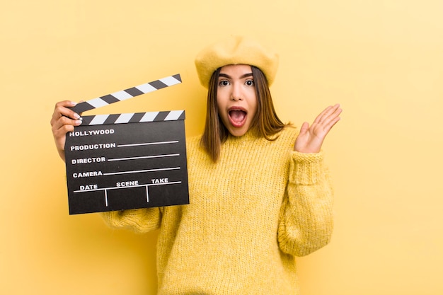 Pretty hispanic girl feeling happy and astonished at something unbelievable cinema concept