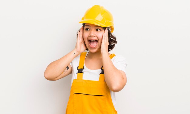 Pretty hispanic girl feeling happy excited and surprised worker concept