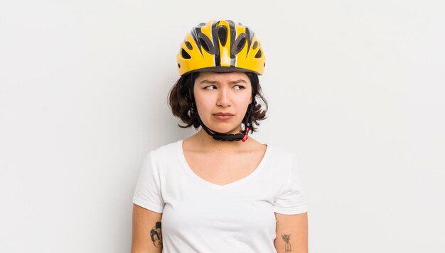 Pretty hispanic girl feeling sad upset or angry and looking to the side bike concept