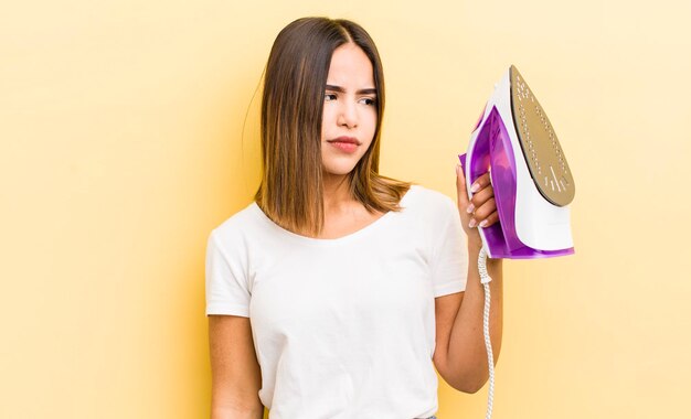 Pretty hispanic girl feeling sad upset or angry and looking to the side housekeeping concept