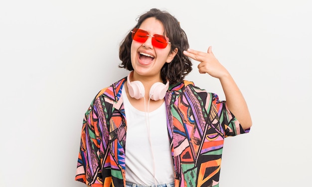 Pretty hispanic girl looking unhappy and stressed suicide gesture making gun sign teenager concept