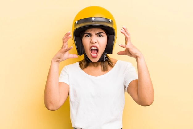 Pretty hispanic girl screaming with hands up in the air motorbike concept