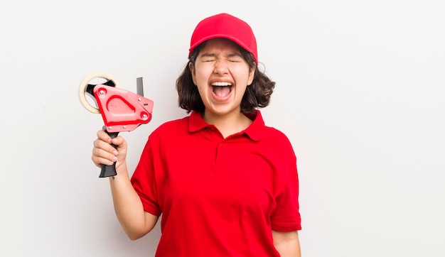 Pretty hispanic girl shouting aggressively looking very angry packer concept