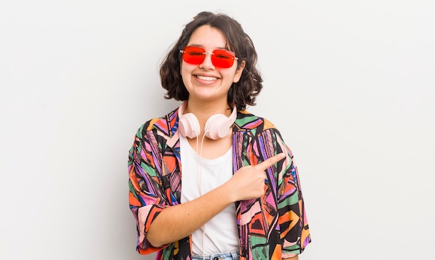 Pretty hispanic girl smiling cheerfully feeling happy and pointing to the side teenager concept