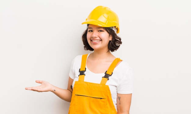 Pretty hispanic girl smiling cheerfully feeling happy and showing a concept worker concept