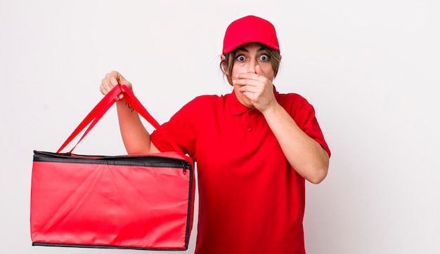 Pretty hispanic woman covering mouth with hands with a shocked delivery pizza concept